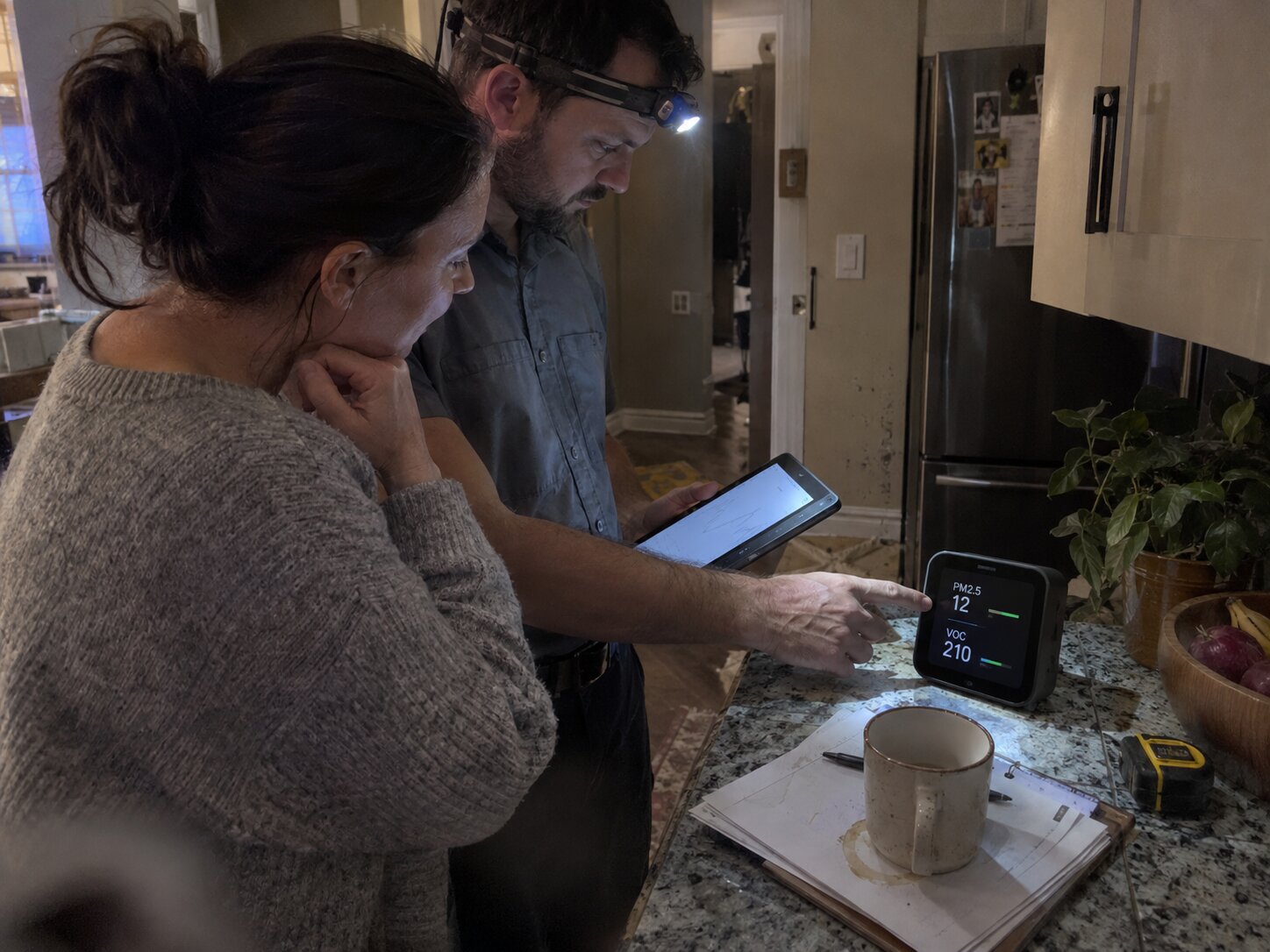 Reviewing an IAQ monitor with a homeowner in Dehumidifiers by 7th Degree Heating and Air