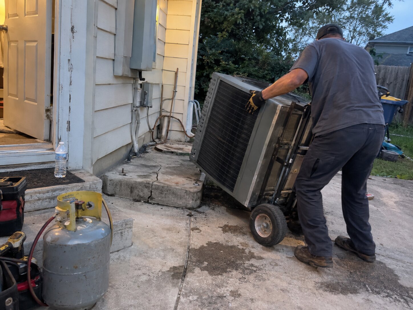 Removing an old condenser during a replacement in Installation by 7th Degree Heating and Air