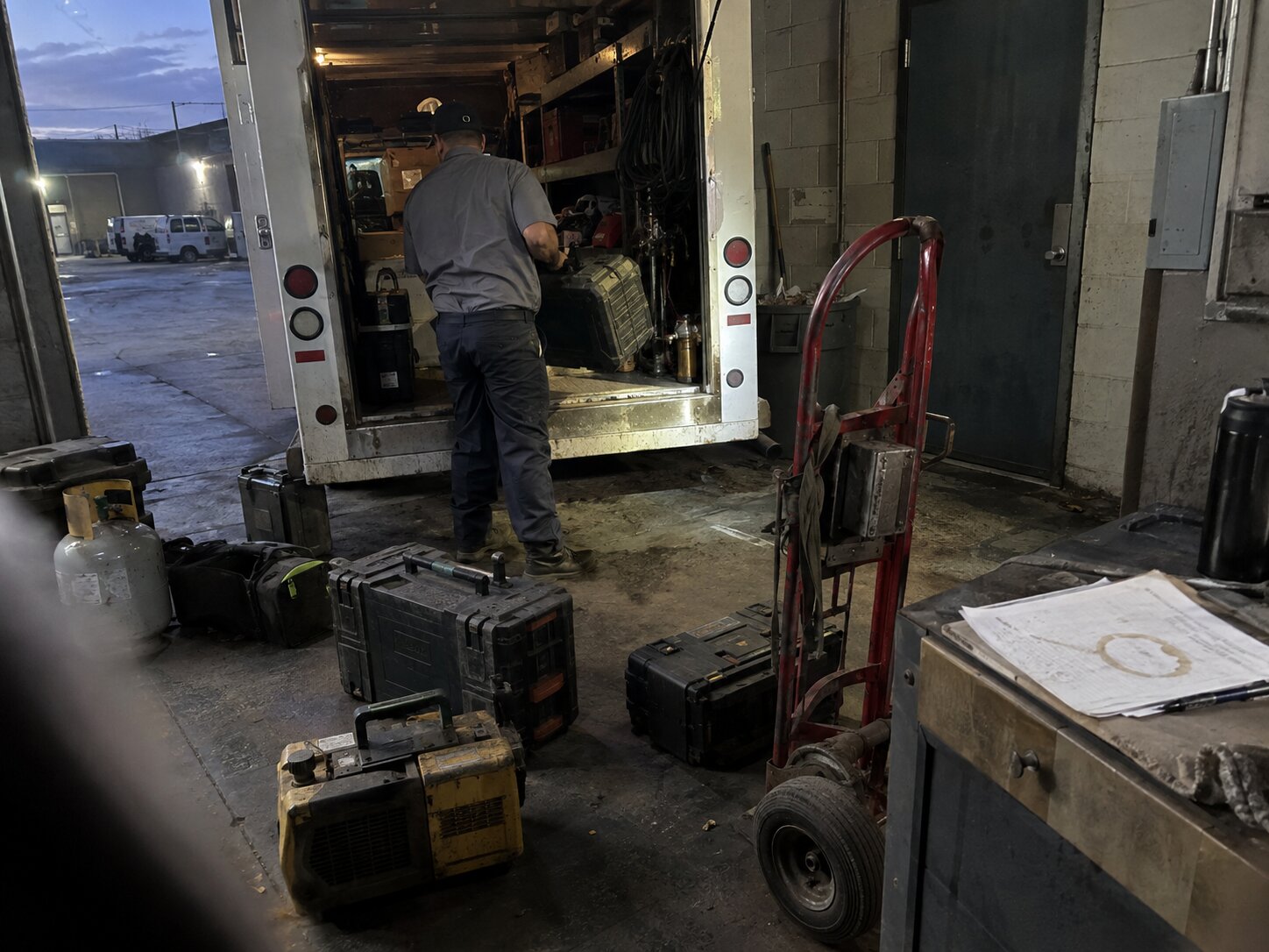 Loading assorted service equipment into a work truck in Evaporator Coil Repair by 7th Degree Heating and Air